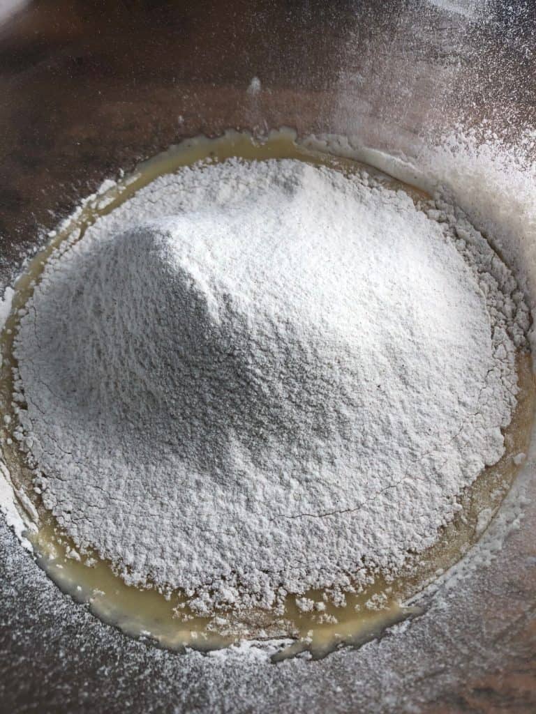 sieved flour mixture into wet banana mixture in a bowl