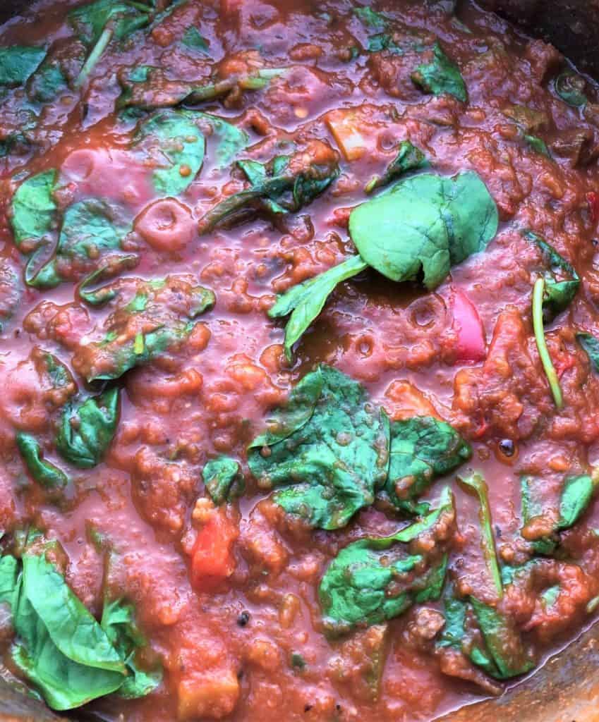 tomato pasta sauce with spinach in pan