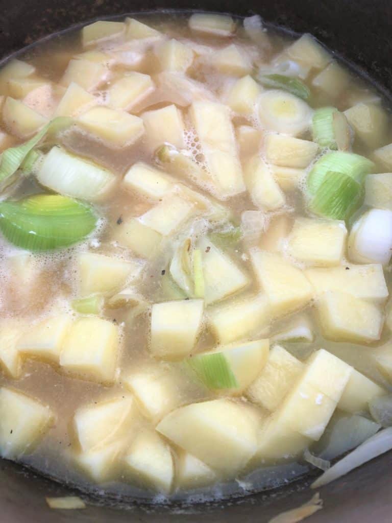 diced potatoes and leeks simmering in stock