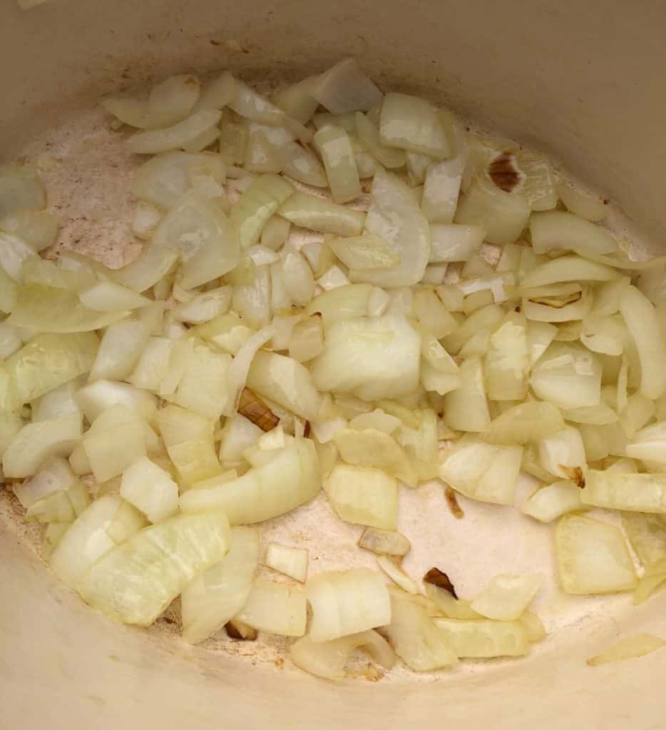 diced onions frying in a pan
