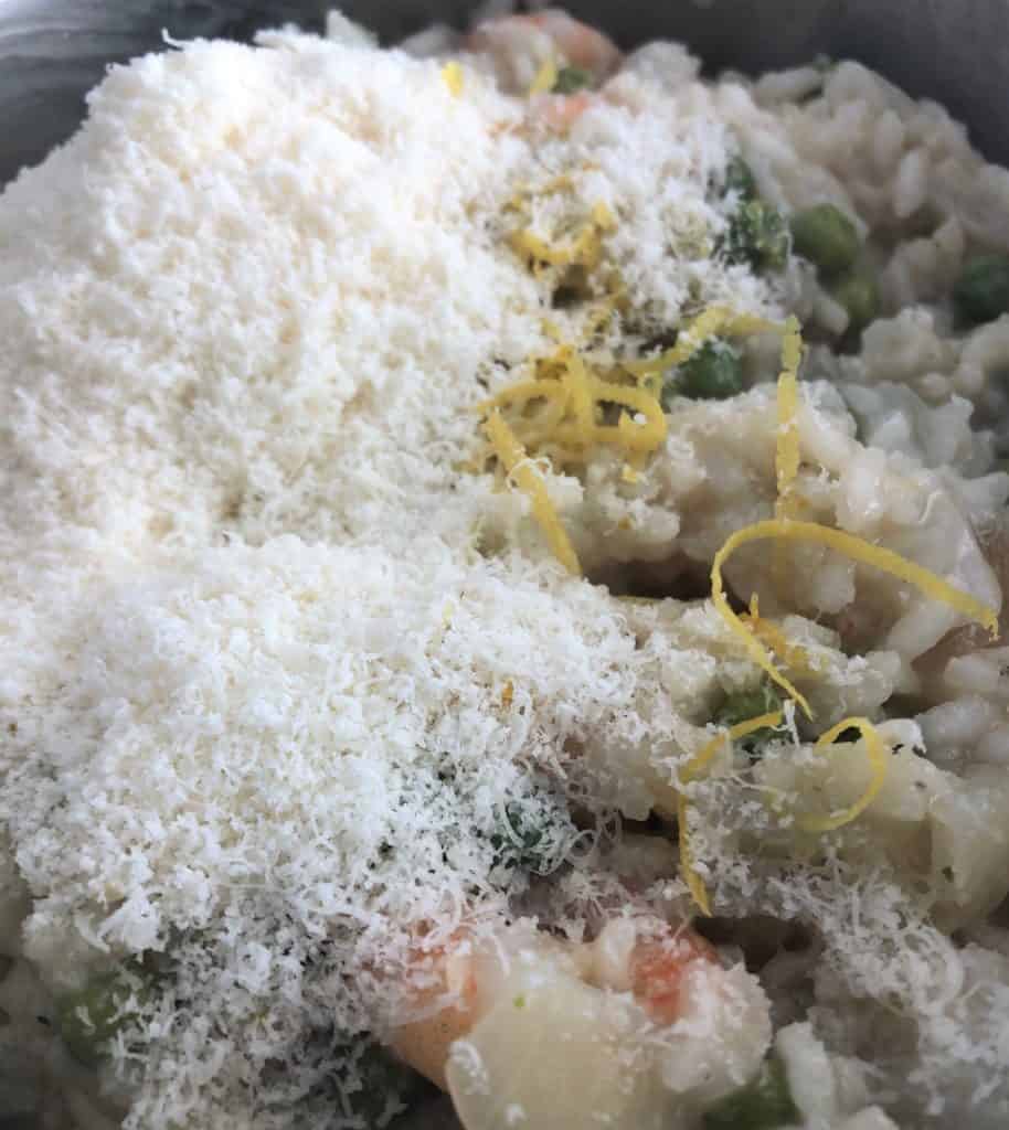 grated parmesan and lemon zest on top prawn pea risotto