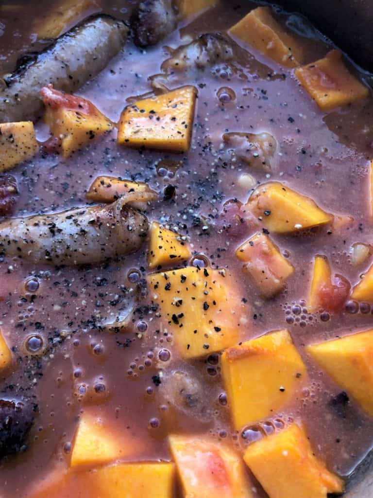 sausages pumpkin in sauce simmering in pan