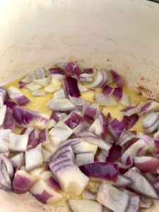 red onions frying in oil and butter in pan