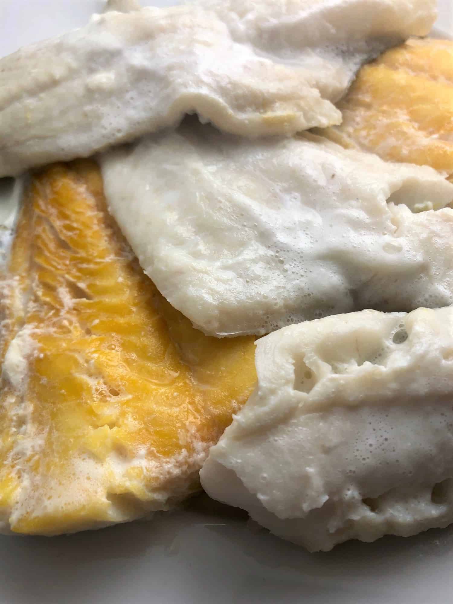poached cod and haddock removed from pan