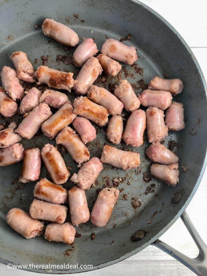 sausages pieces frying in pan