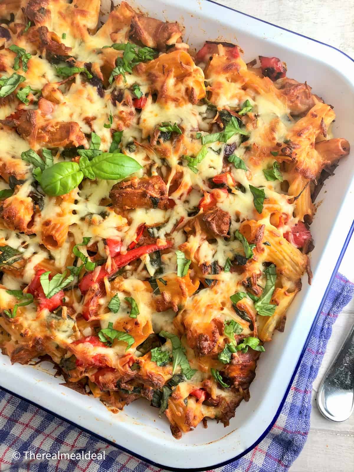 Sausage Pasta Bake cooked in tray topped with fresh basil