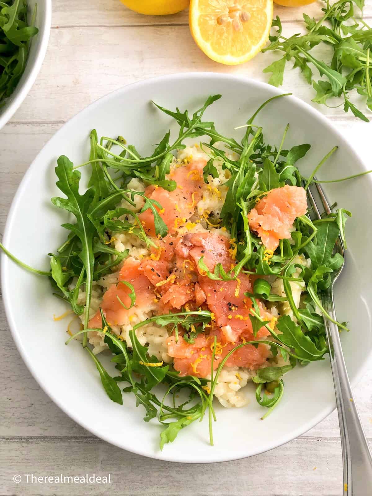 smoked salmon with a lemony risotto served with rocket leaves