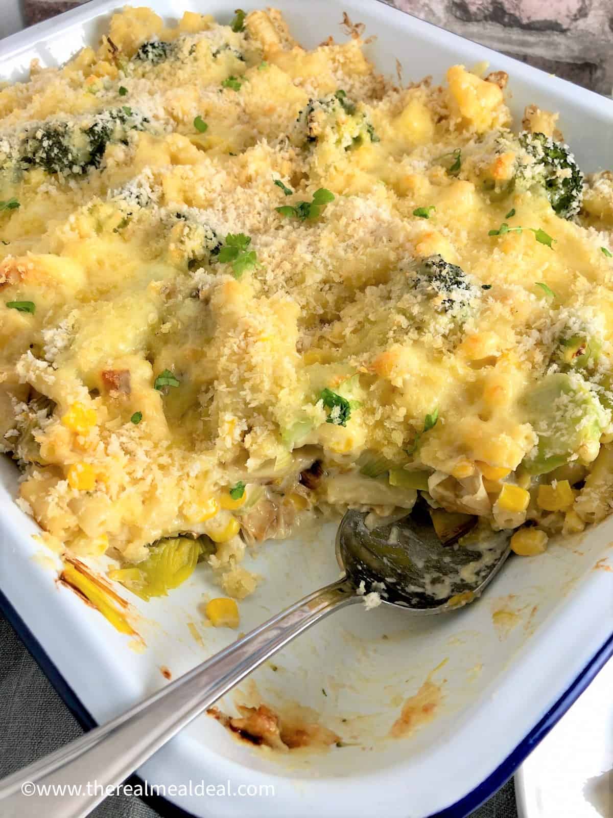 baked macaroni in tray with portion served