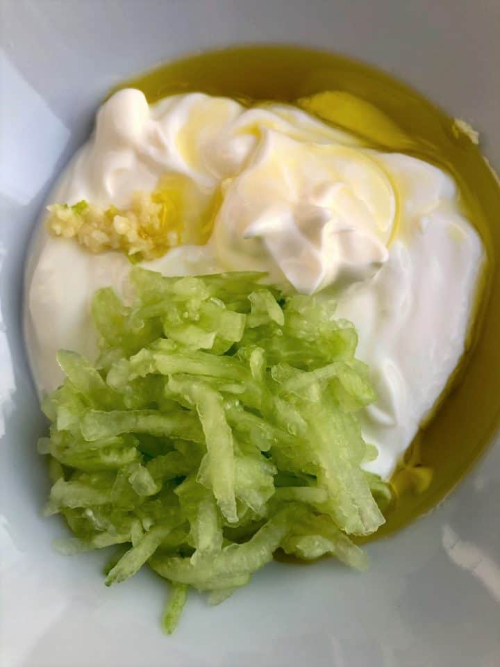tzatziki ingredients natural yoghurt grated cucumber crushed garlic lemon juice olive oil in bowl