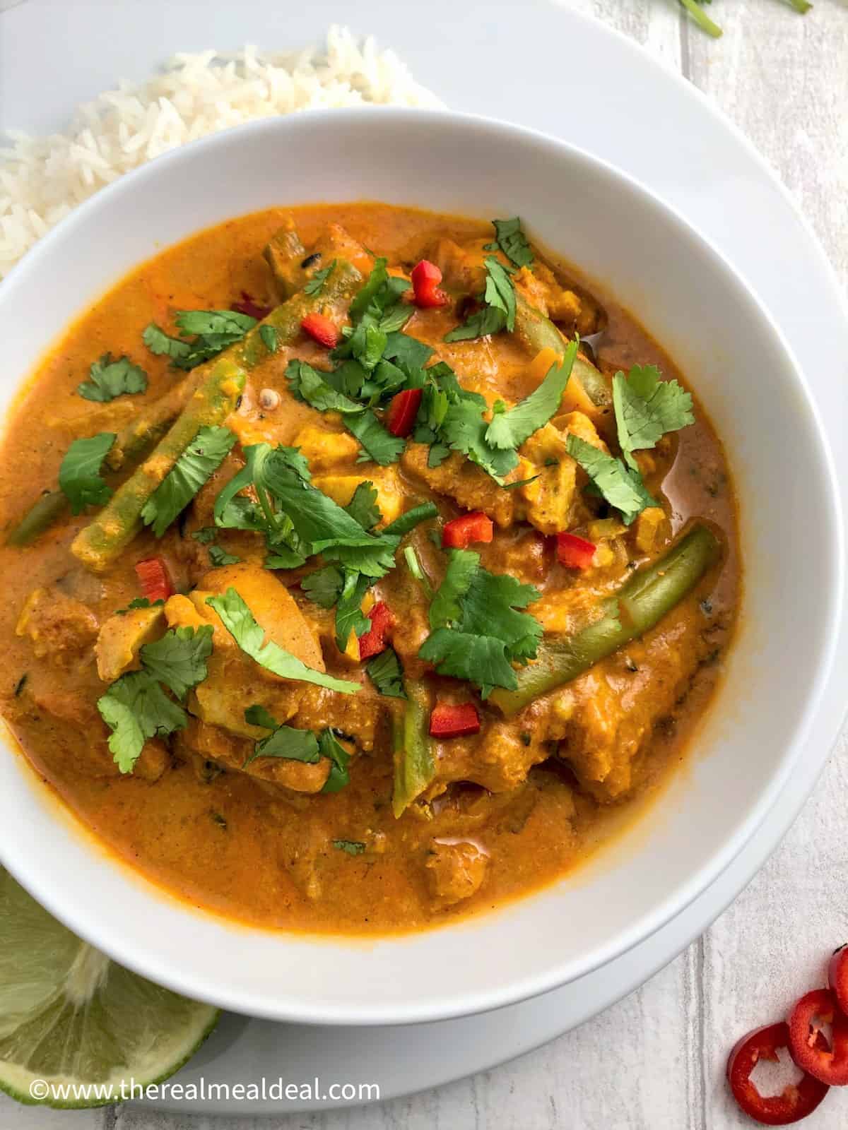 keralan fish curry in a bowl topped with fresh coriander leaves
