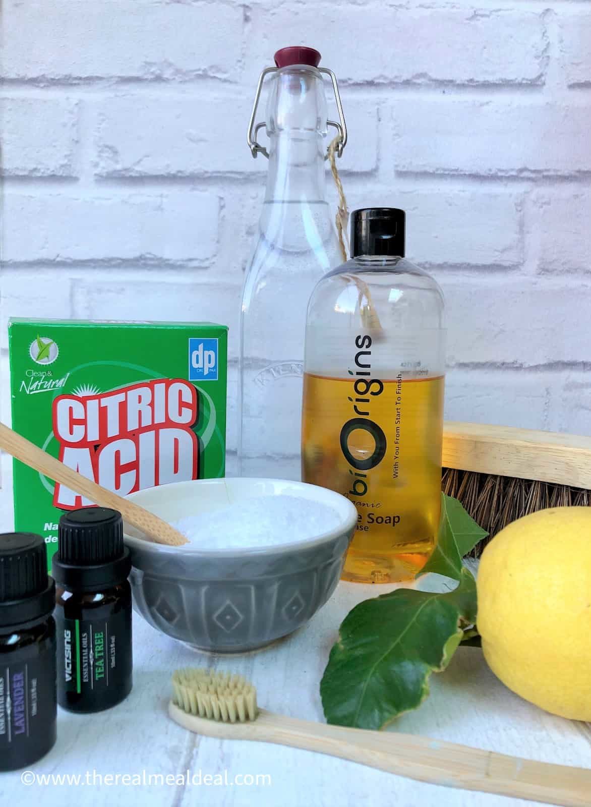 eco cleaning products essential oils box citric acid white vinegar castile soap lemon hard wooden brush used toothbrush dishwasher salt in bowl