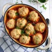 winter vegetable stew topped with vegan dumplings in a casserole dish