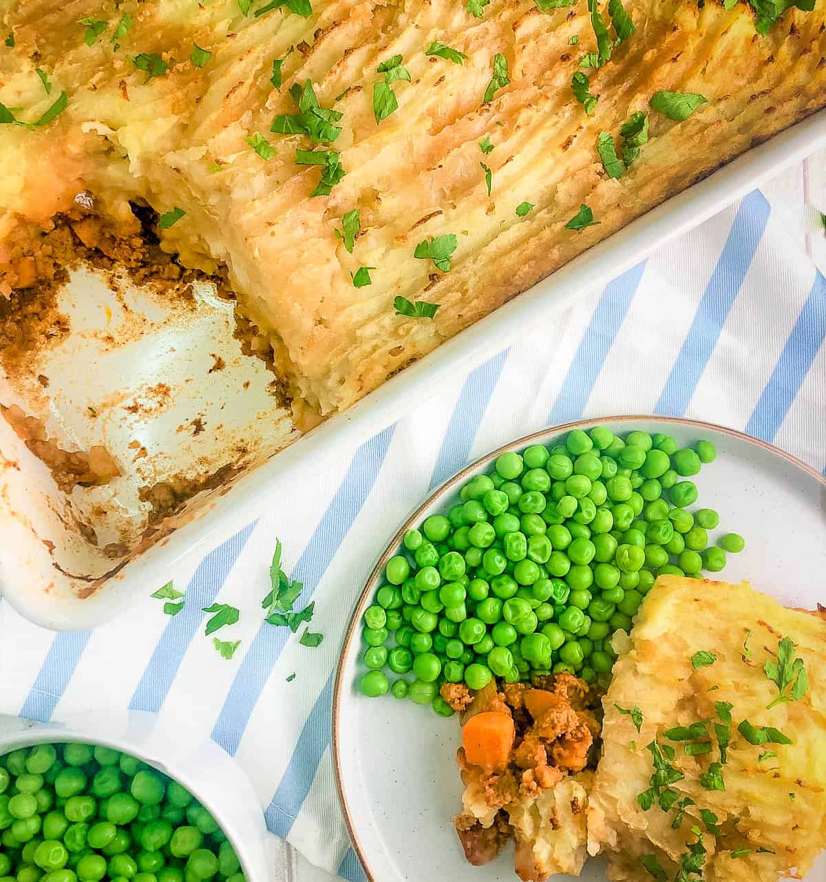 quorn cottage pie portion on plate with side garden peas