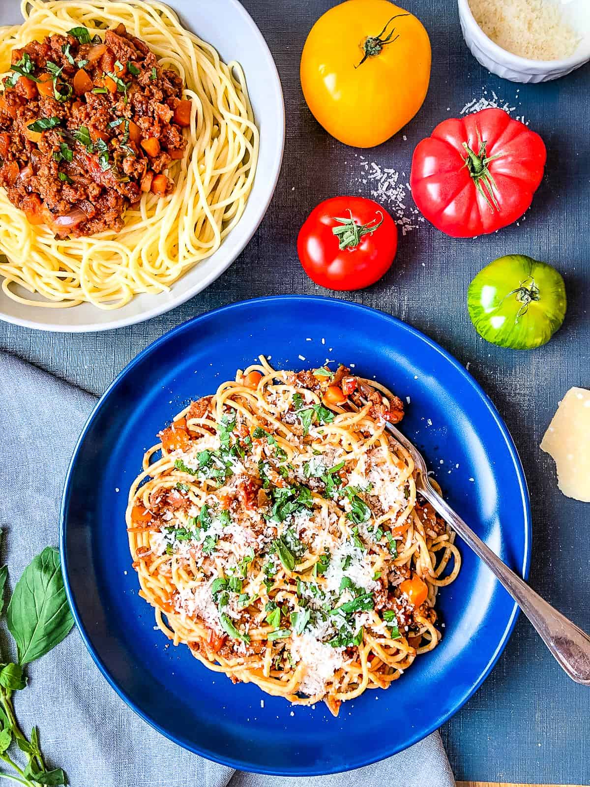 quorn vegetarian bolognese sauce mixed with spaghetti in a bowl topped with parmesan cheese