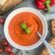 roasted red pepper soup topped with fresh basil and black pepper