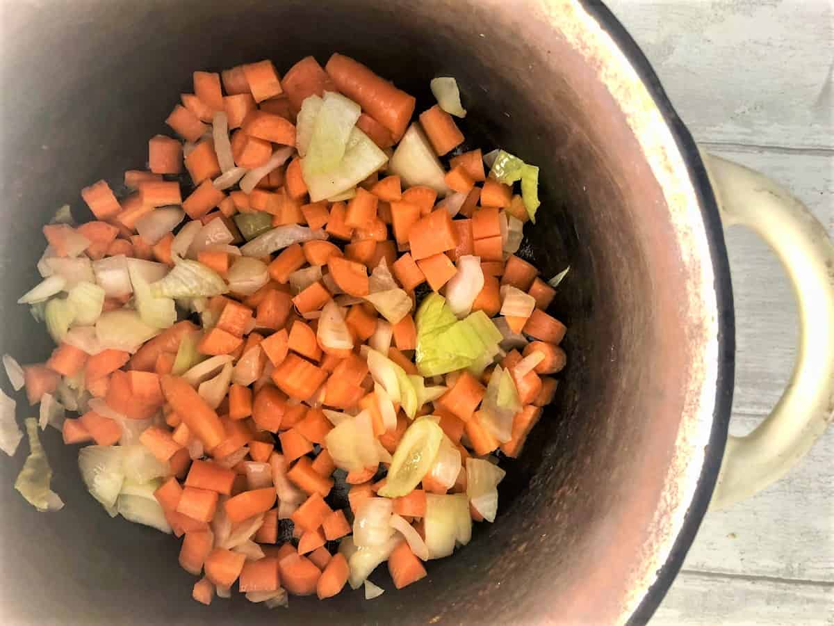 carrots and onions frying in pan
