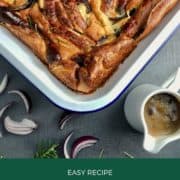 Vegan Toad in the Hole topped with red onion and rosemary pinterest image