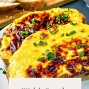 welsh rarebit pinterest image with two slices of rarebit on a plate