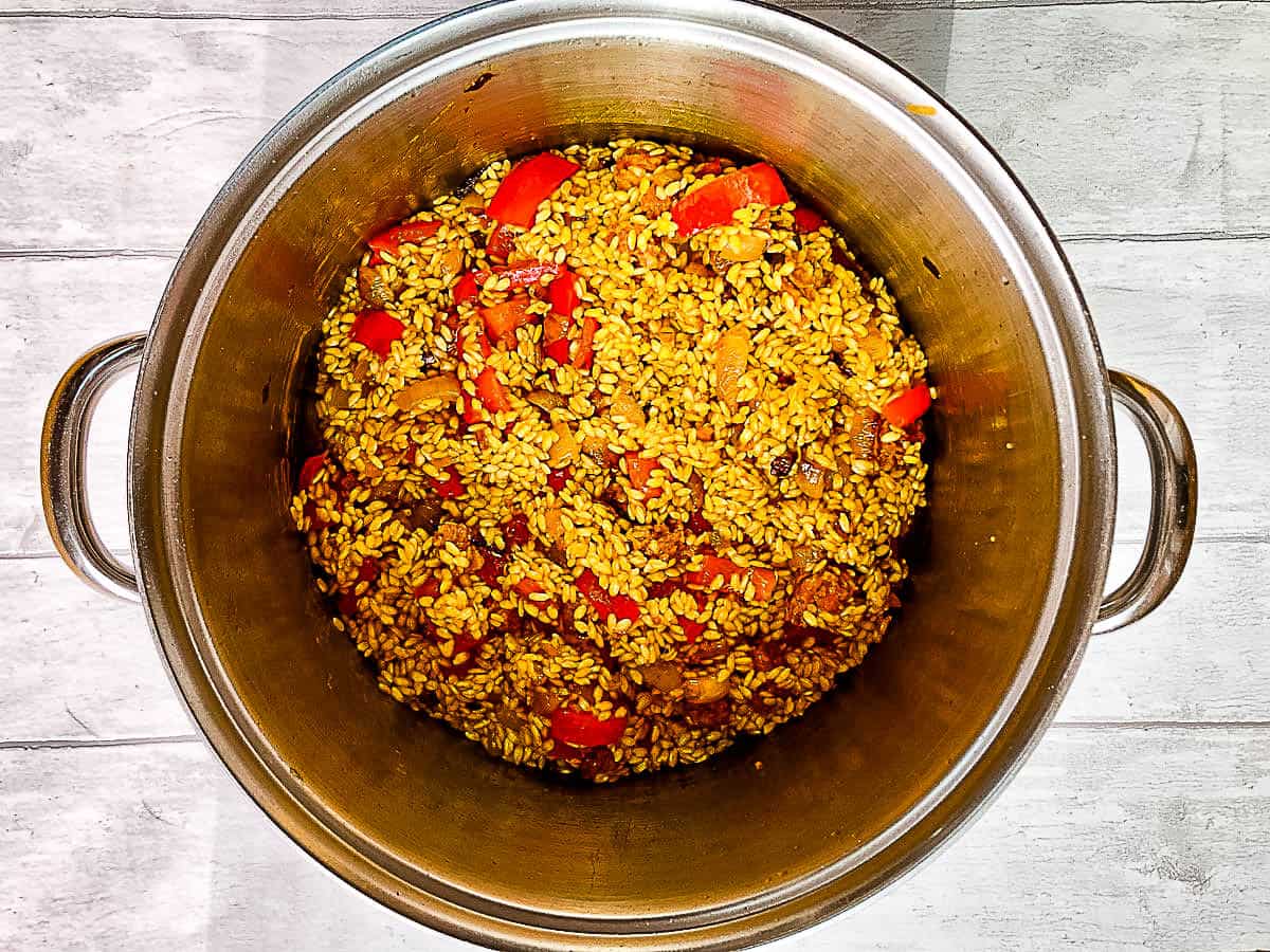 tumeric added to arborio rice chorizo red peppers and onions.