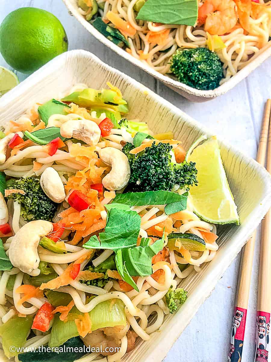 prawns with vegetable stir fry and noodles in square bowl with chopsticks