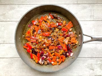 thai red curry paste added to red onion and red pepper.