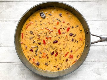 coconut milk added to pan with curry ingredients