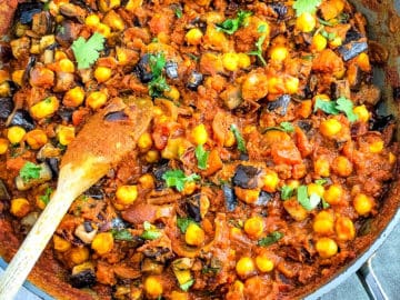 aubergine and chickpea curry stirred together in pan