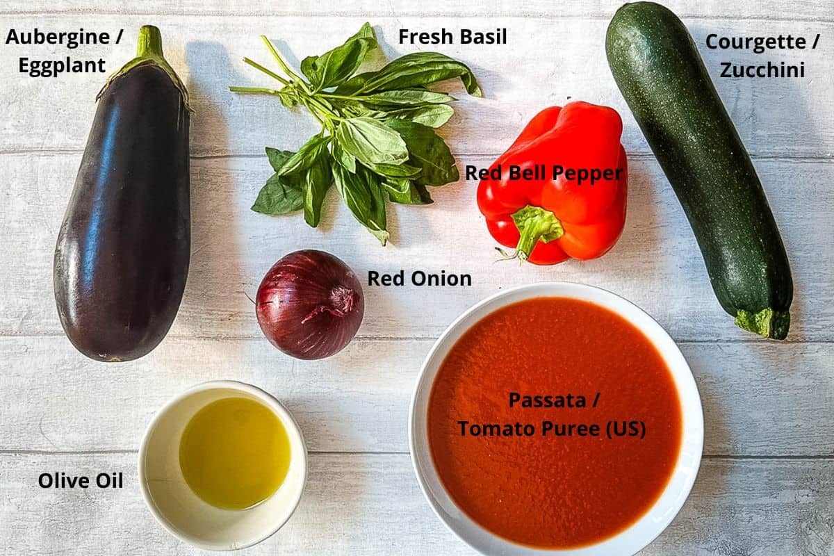image of labelled ingredients aubergine, fresh basil, red pepper, courgette, red onion, passata and olive oil.